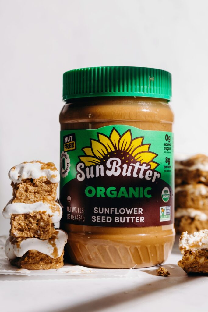 Organic SunButter jar surrounded by Fluffernutter Protein Bars