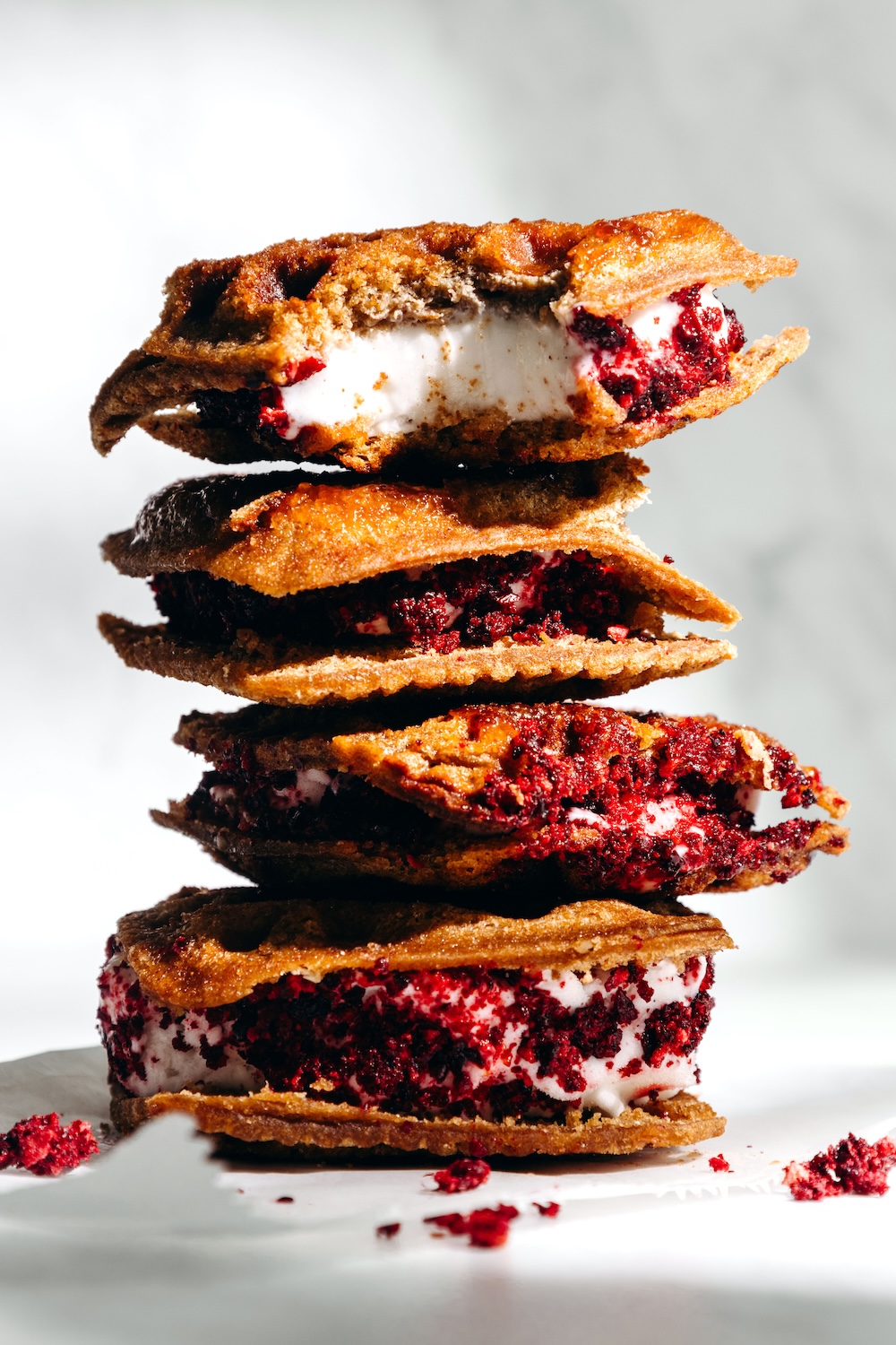 Stack of cinnamon sugar Jammies pressed in waffle iron golden and crispy and sandwiched with vanilla ice cream